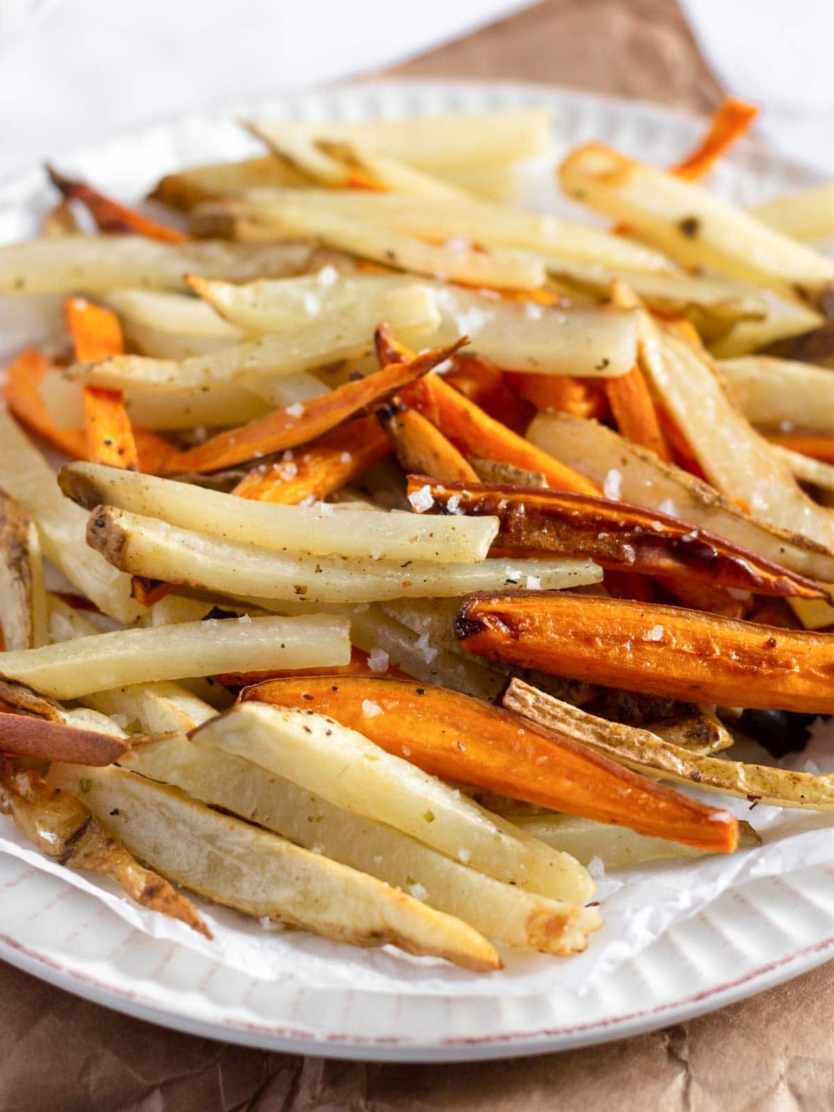 Assembly of homemade Vegan Fries and Sweet Potato Fries on a plate.