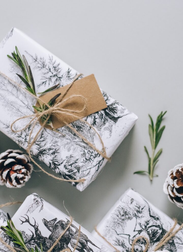 wrapped gifts surrounded by pine cones