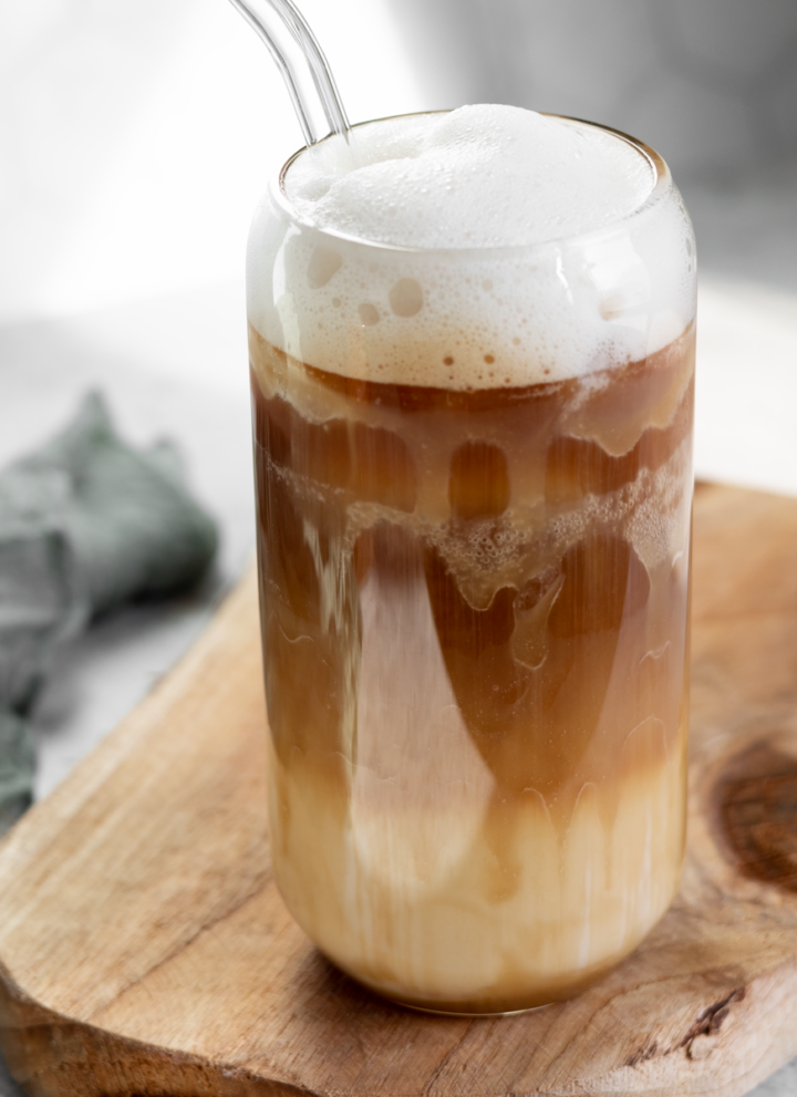 iced brown sugar latte served in a latte glass with caramel sauce
