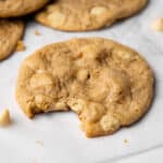 Biteshot of baked vegan white chocolate macadamia cookies.