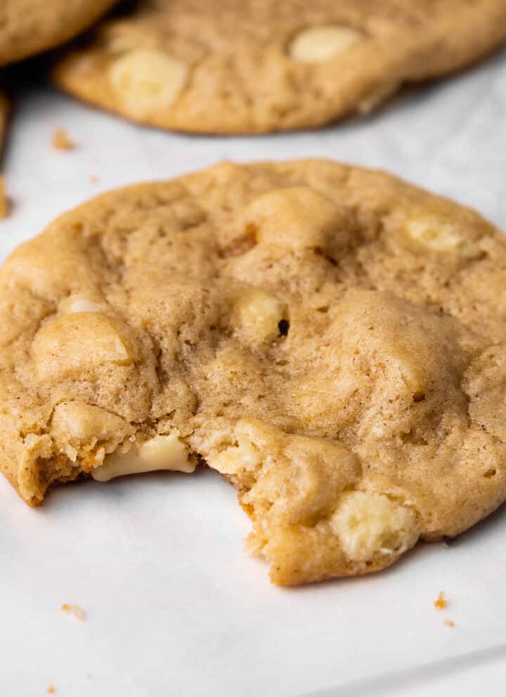 Biteshot of baked vegan white chocolate macadamia cookies.