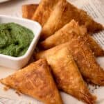 Cocktail Samosa assembled on a plate with coriander chutney.
