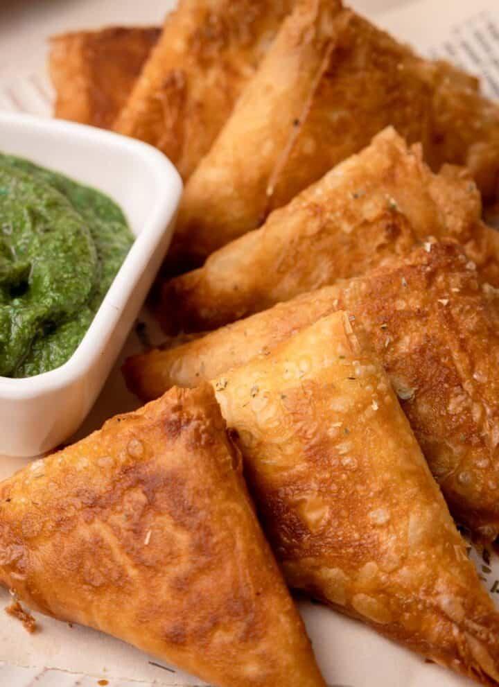 Cocktail Samosa assembled on a plate with coriander chutney.