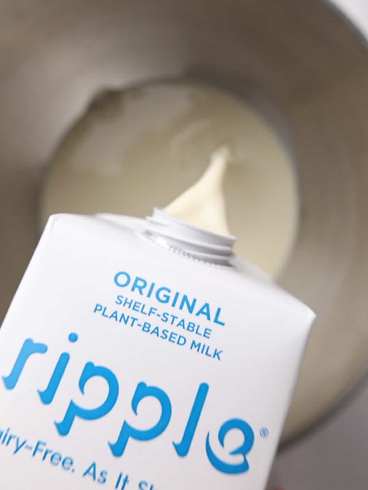 Ripple milk is poured into a mixing bowl.