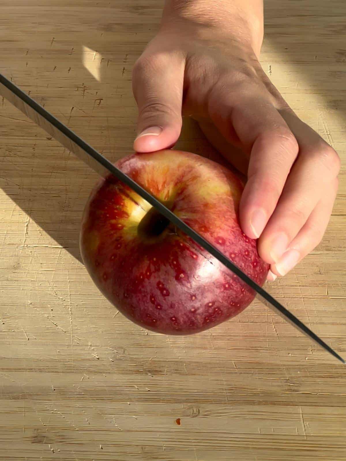 Cutting an apple in half.
