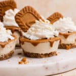 Mini Biscoff Cheesecakes served on a round marble serving platter.